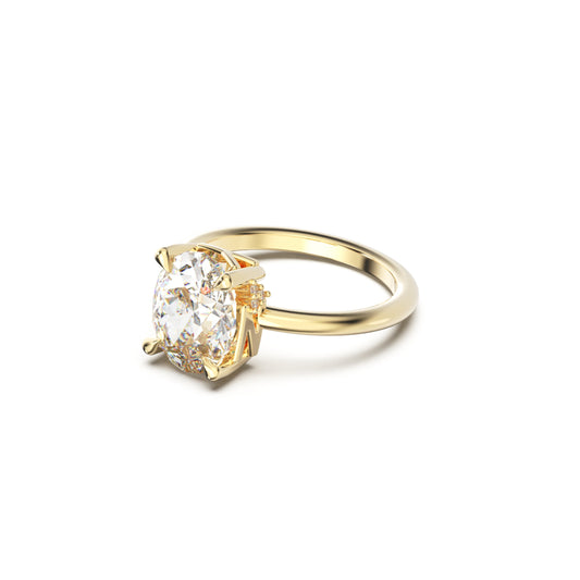 Gold ring with a large diamond on a white background
