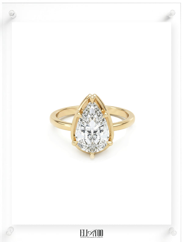 Front view of Pear cut diamond yellow gold ring