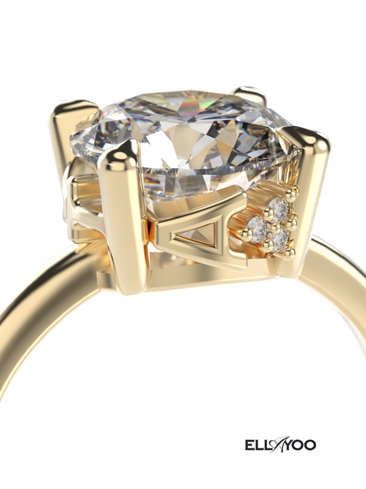 Gold engagement ring with name engraving detail and a large diamond on a white background