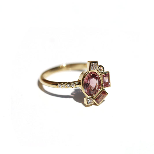 Gold engagement ring with Pink sapphire on a white background