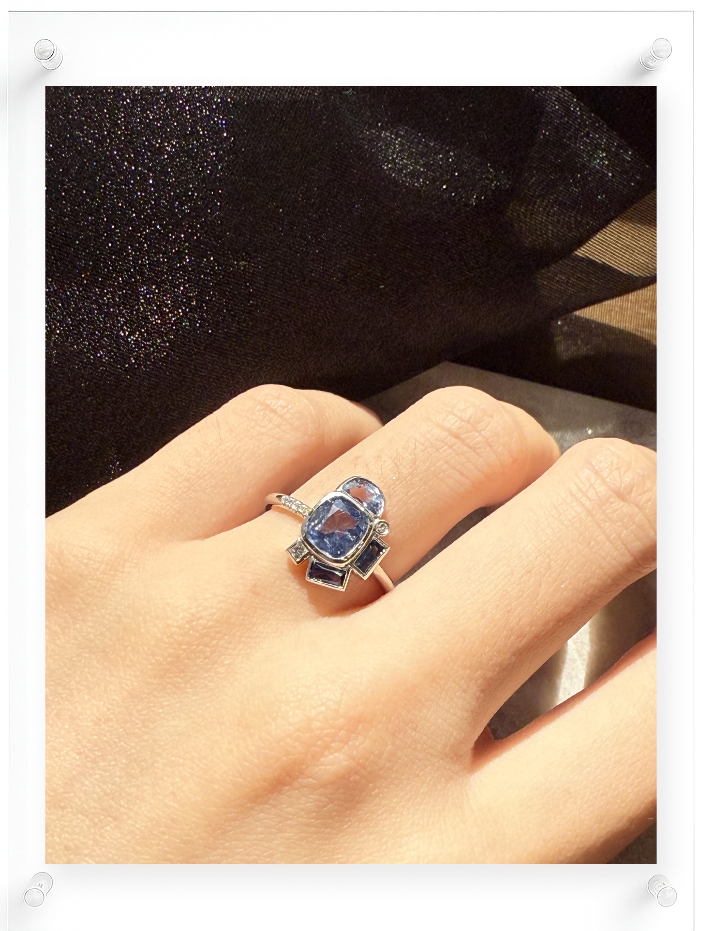 Model wearing shot of Contemporary bauhaus design blue sapphire ring in platinum
