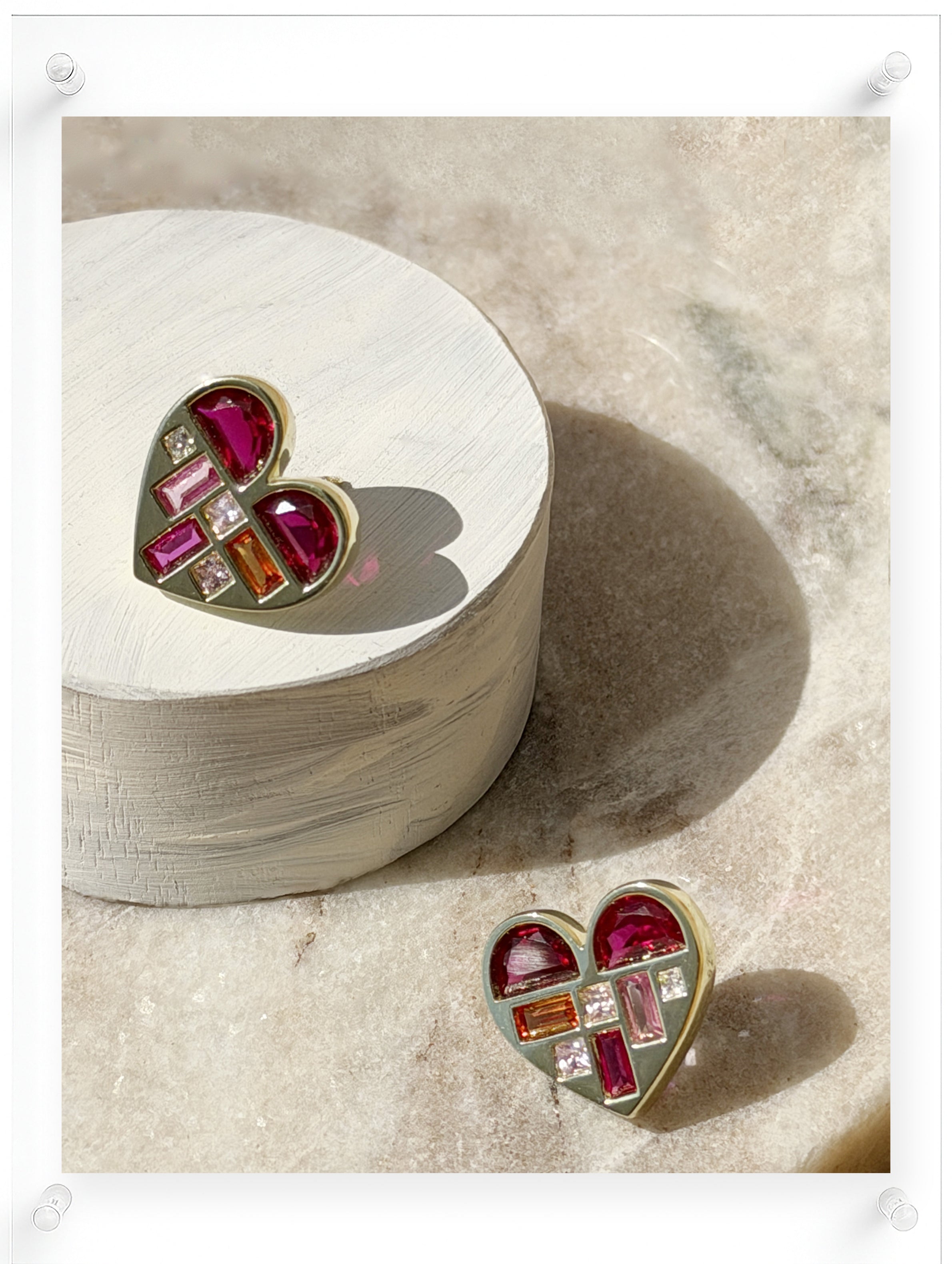 Heart-shaped stud earrings in 14K yellow gold with pink and orange gemstone mosaic by Ella Yoo Jewelry
