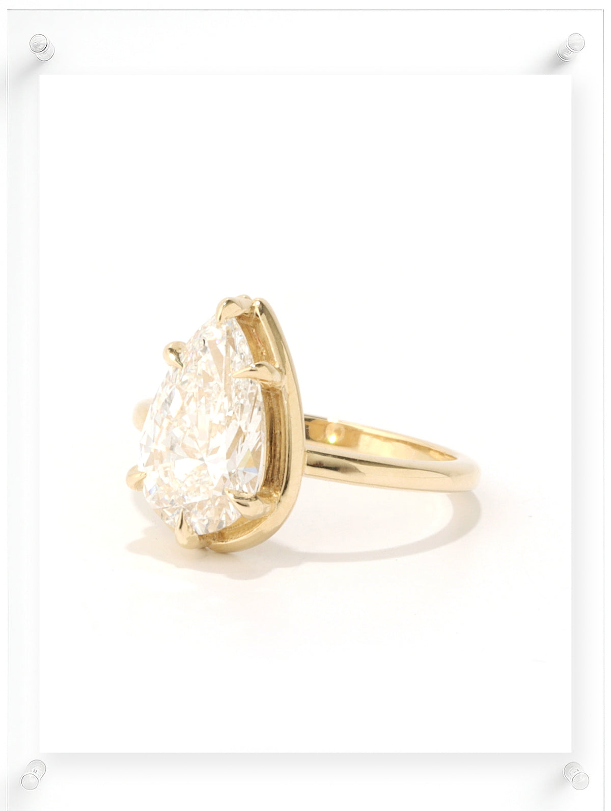 Side view of Pear cut diamond yellow gold ring
