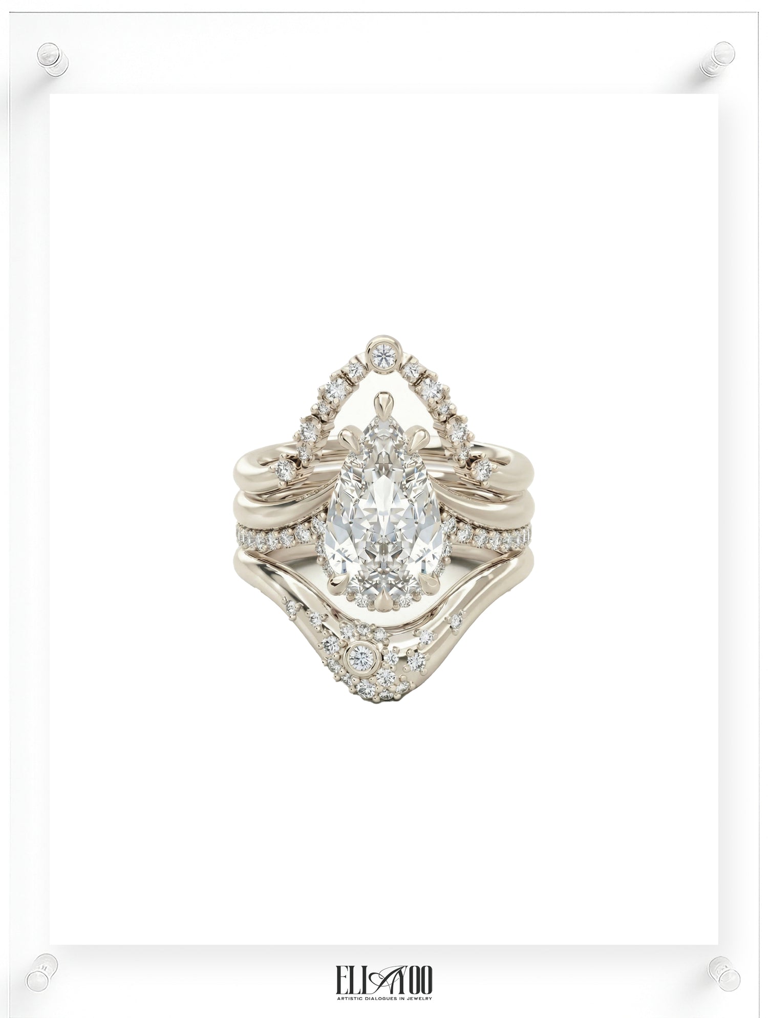 Diamond ring with a pear-shaped center stone with 2 stackable rings on a white background