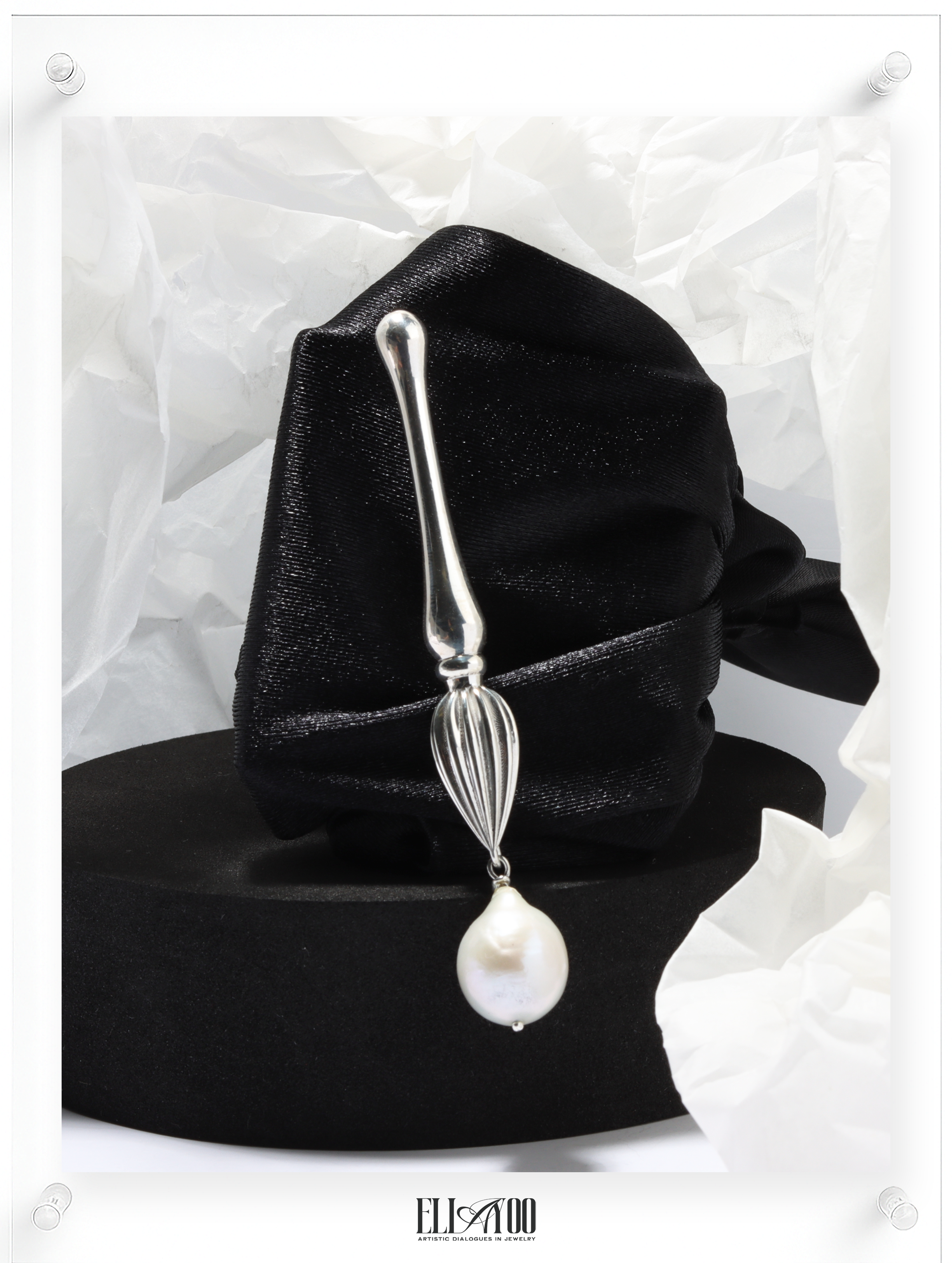 Front view of Silver brooch featuring a paint brush shape with a pearl