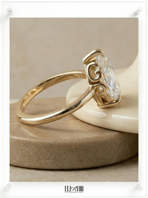Side view of Pear Cut Diamond Ring with claw setting featuring initials on the side