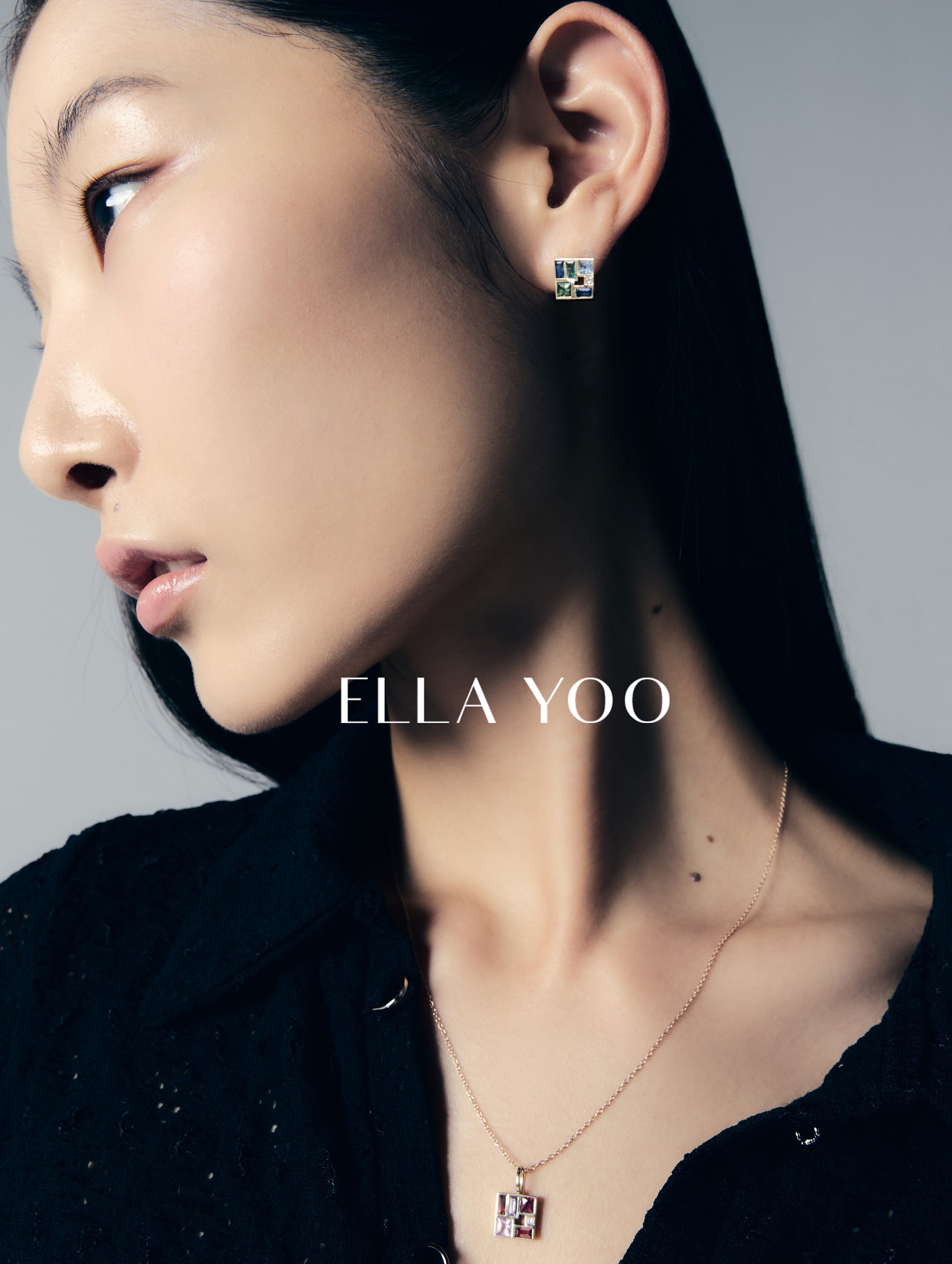 Close-up of a person wearing earrings with 'ELLA YOO' branding.
