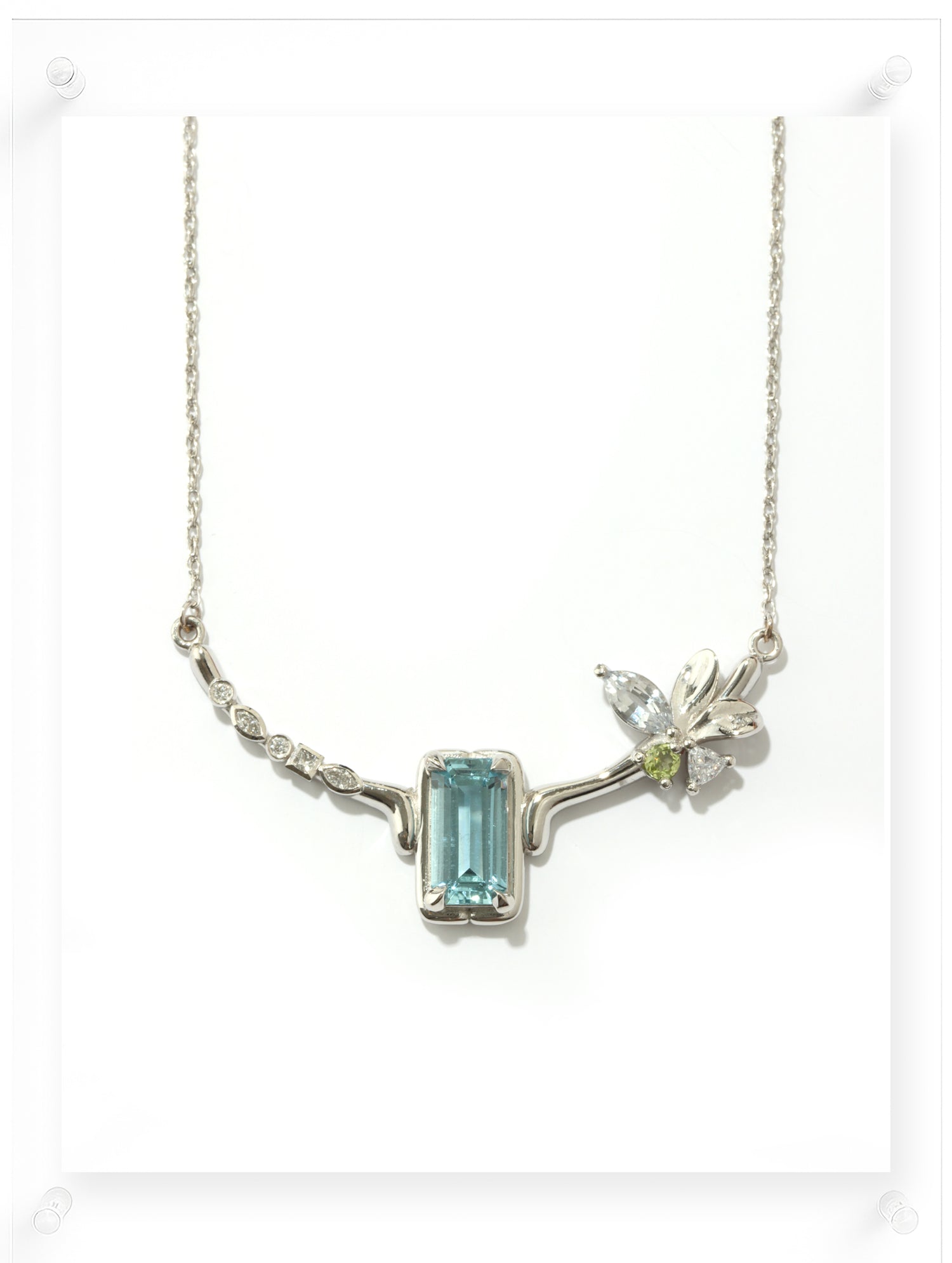 Necklace with a blue gemstone pendant on a white background