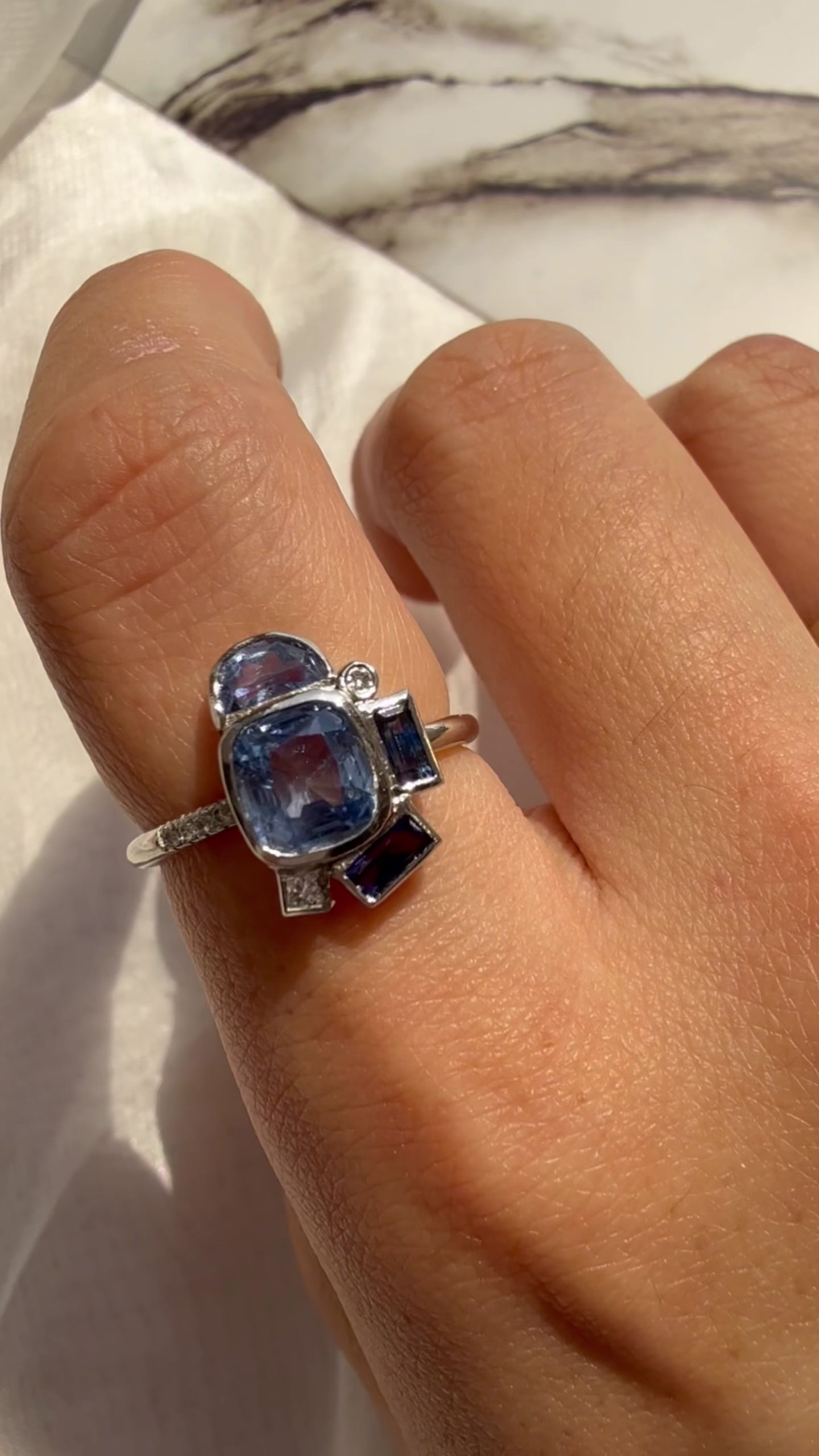 Video showingshot of Contemporary bauhaus design blue sapphire ring in platinum
